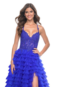 La Femme 32128 Dreamy Ruffle Tulle Tiered Prom Dress - A captivating prom dress featuring a dreamy ruffle tulle tiered skirt, high slit, and intricate lace applique details for an enchanting and sophisticated look. The model is wearing royal blue.