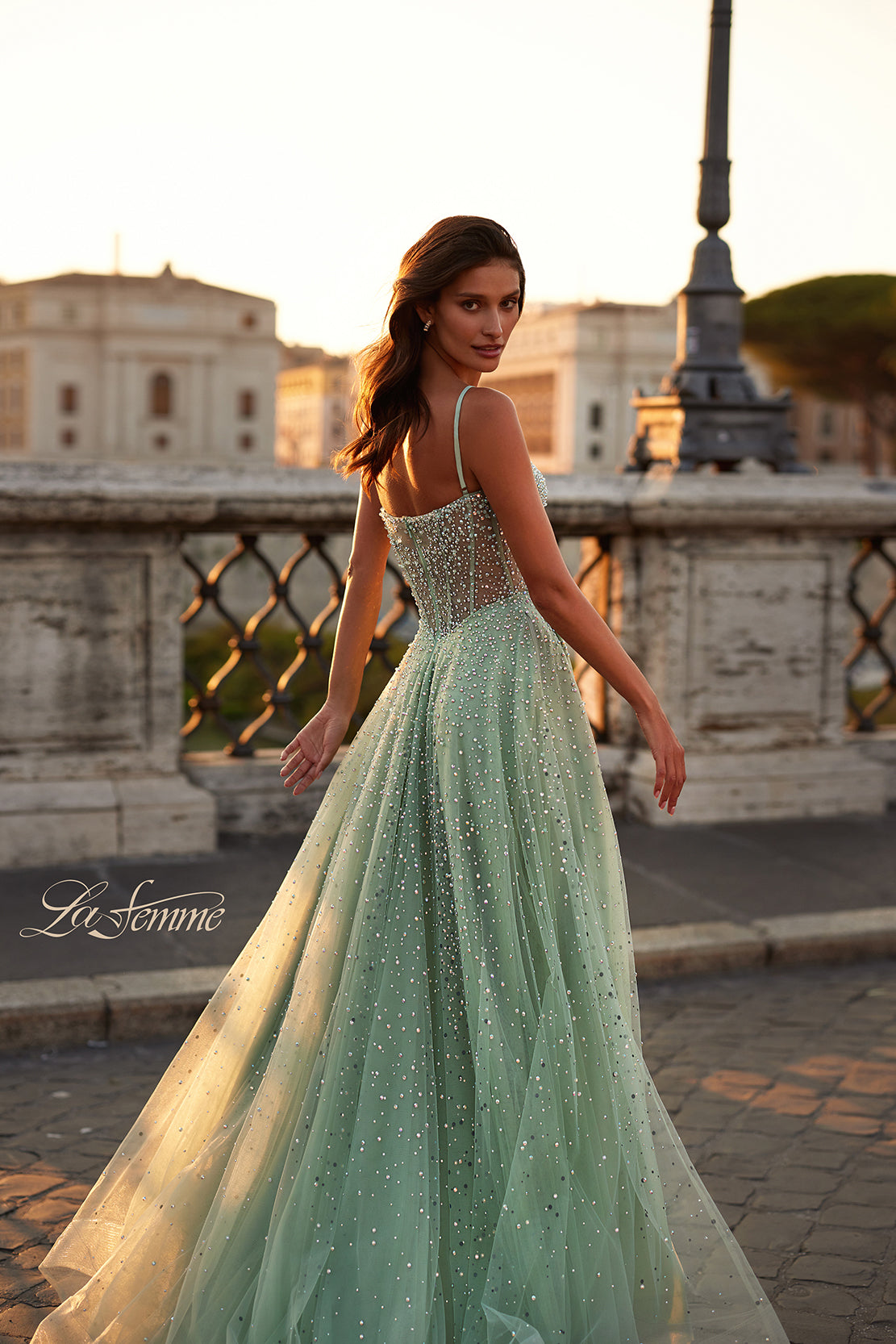 La Femme 32146 Radiant Rhinestone Illusion A-Line Prom Gown - An enchanting prom gown featuring radiant large rhinestones, an alluring illusion bustier bodice, and a V neckline for a dazzling and sophisticated look. The model is wearing sage green.