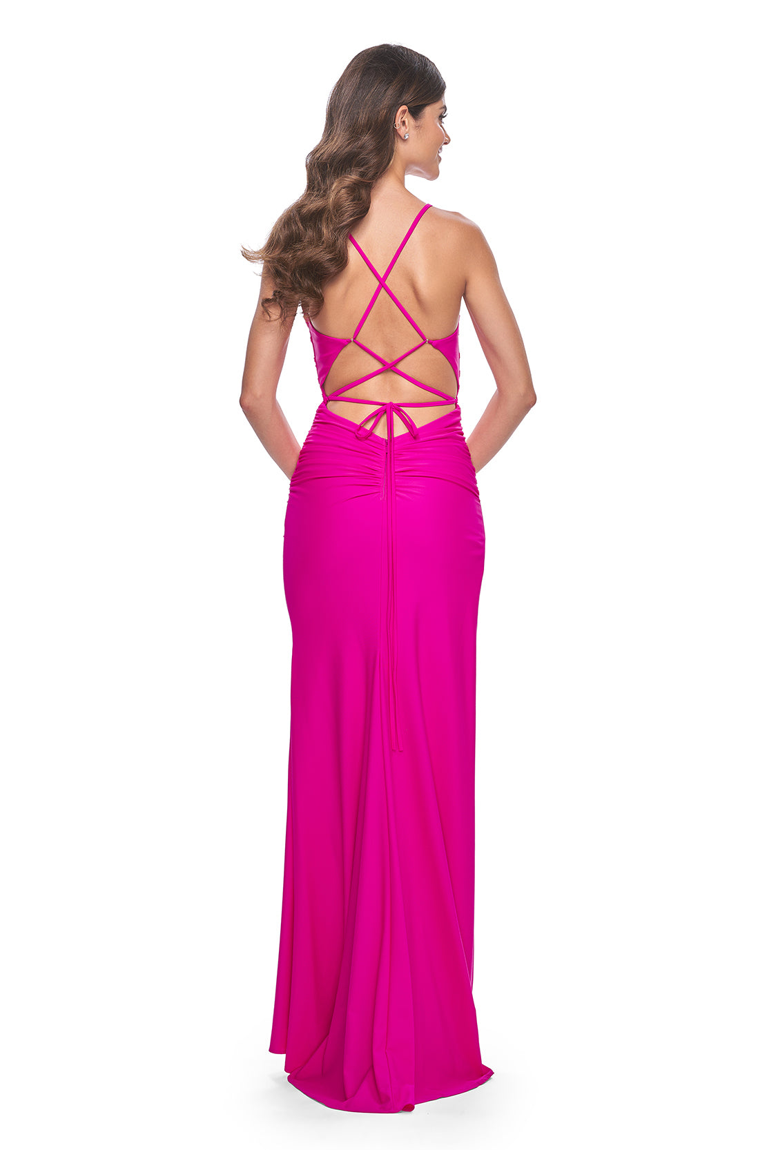 La Femme 32152 Ruched Jersey Prom Dress - Elevate your prom look with this meticulously ruched jersey gown featuring a gracefully draped neckline, an alluring open lace-up back, and a high slit for added glamour.  The model is wearing the dress in the color hot fuchsia.