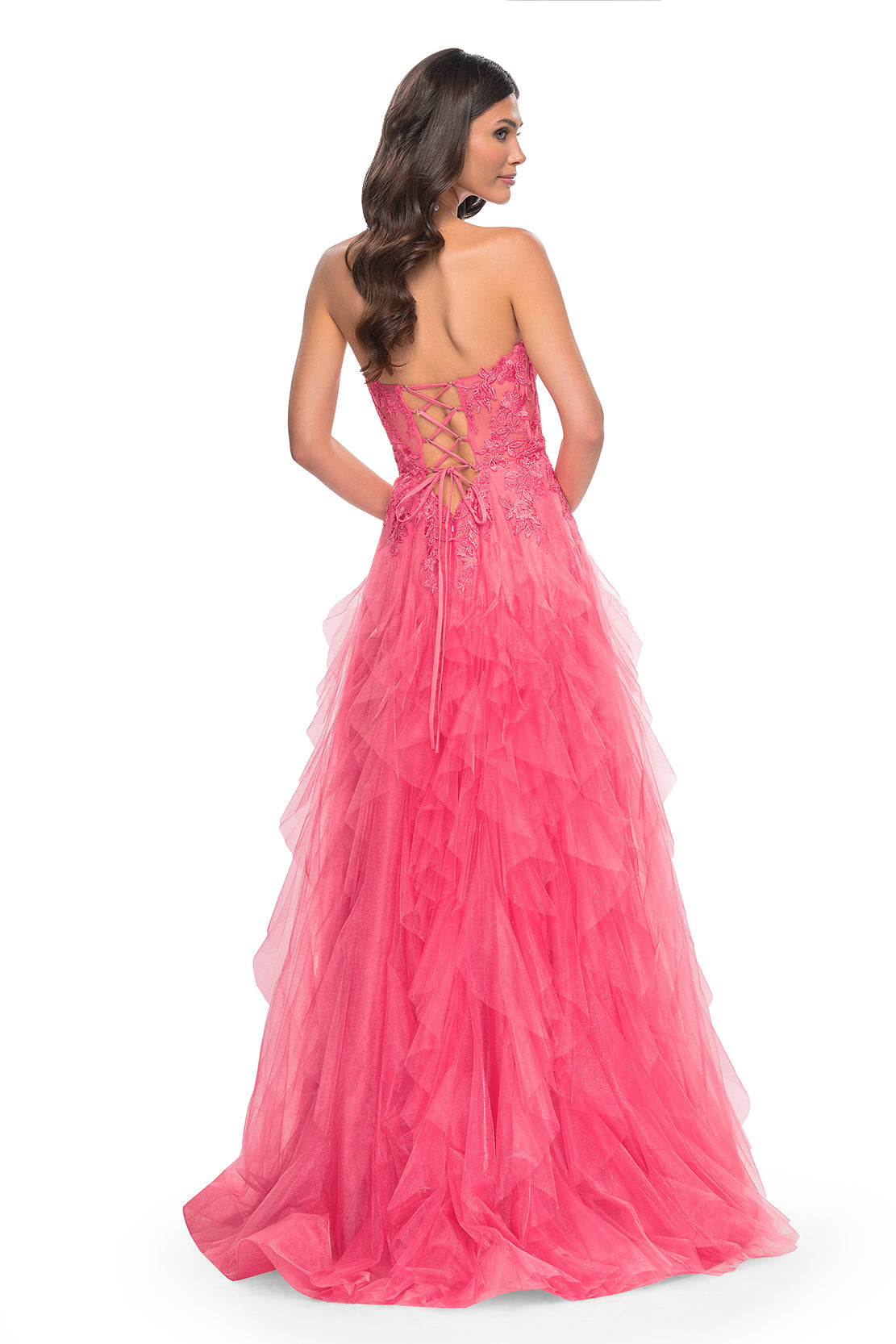 La Femme 32286 Illusion Lace Bustier A-Line Prom Gown - A captivating A-line gown featuring a ruffle tulle skirt, high slit, and illusion lace bustier bodice for a glamorous and sophisticated prom look. The model is wearing the dress in the color coral.