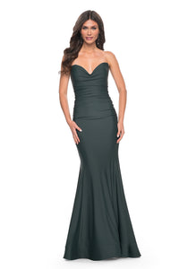 La Femme 32289 Soft Jersey Mermaid Prom Dress - A captivating prom dress in soft jersey with a flattering mermaid silhouette, draped neckline, lace-up back, and a structured hem.  The model is wearing the dress in the color dark emerald.