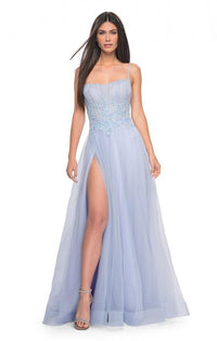 La Femme 32293 - A graceful A-line tulle prom gown featuring a high slit, square neckline, and beaded lace applique for an enchanting look. The model is wearing the dress in light periwinkle.