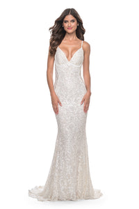 La Femme 32309 Beaded Lace Mermaid Prom Gown - An enchanting prom gown with a beaded lace mermaid silhouette, open lace-up back, and sheer lace panels on both sides. The model is wearing the dress in the color white.