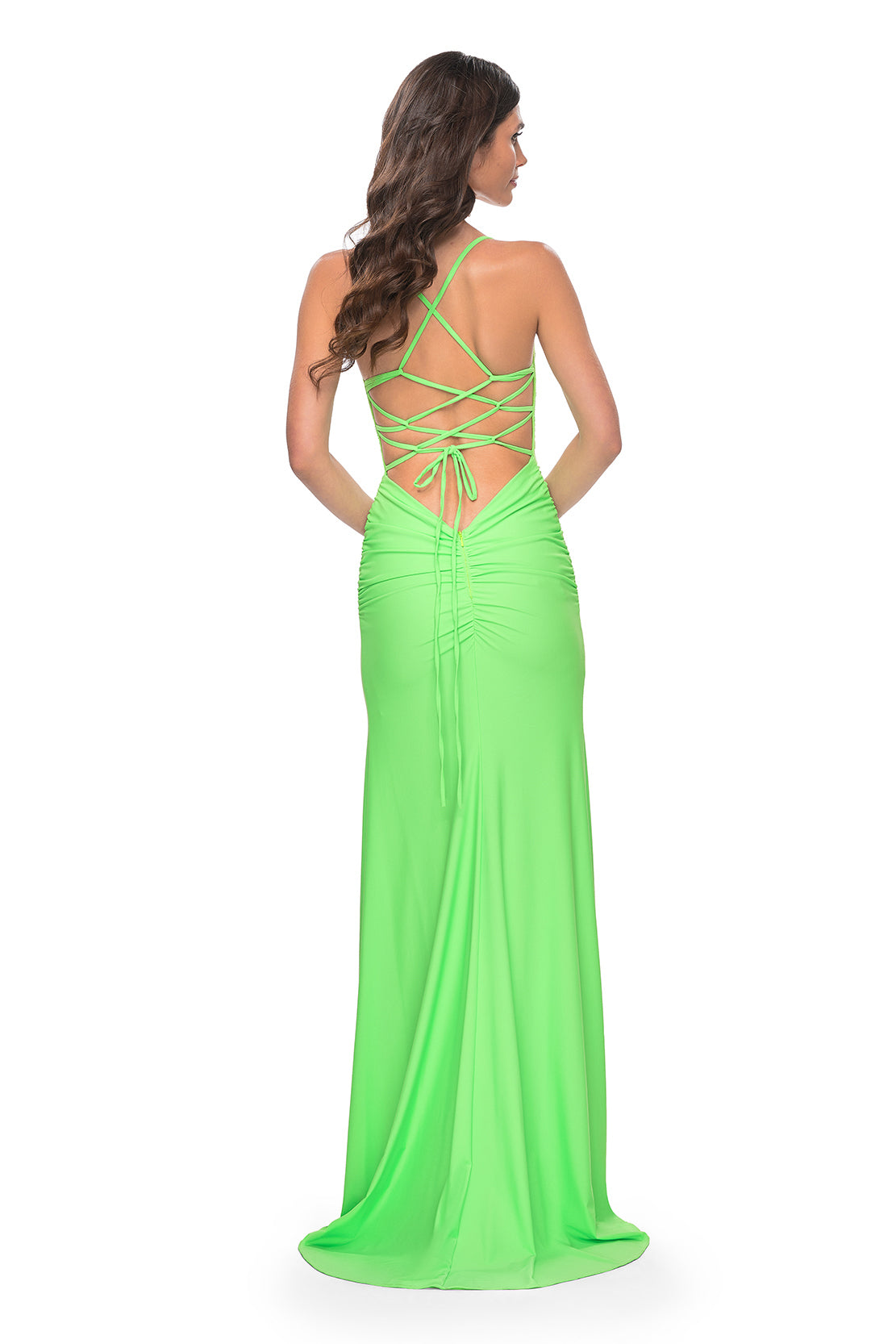 La Femme 31988 Rhinestone Embellished Lace Bodice Prom Gown - A glamorous long dress featuring a ruched jersey skirt, high slit, rhinestone embellished lace bodice with exposed boning, lace-up back, and ruching along the zipper for a perfect fit. The model is wearing the dress in bright green.