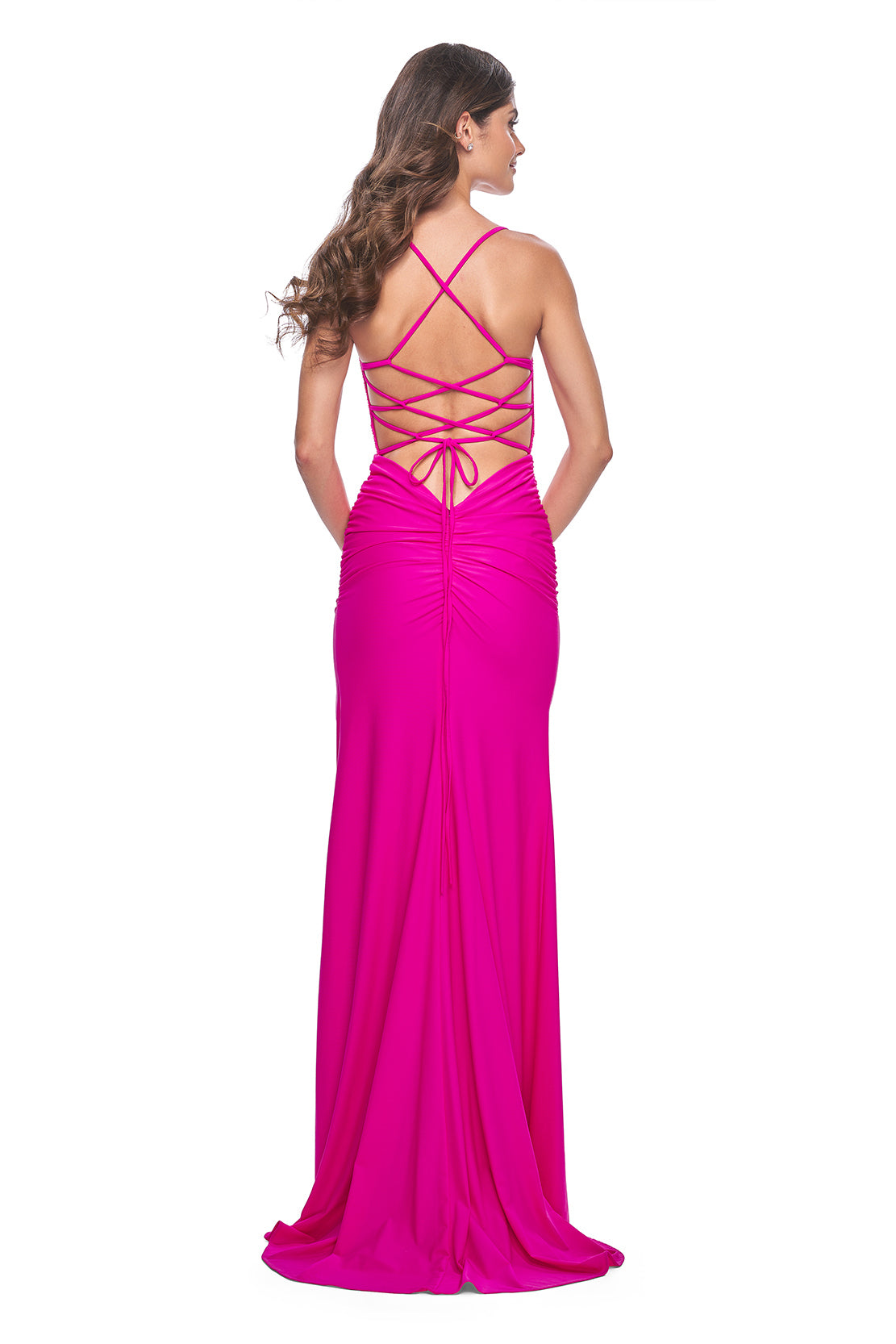 La Femme 31988 Rhinestone Embellished Lace Bodice Prom Gown - A glamorous long dress featuring a ruched jersey skirt, high slit, rhinestone embellished lace bodice with exposed boning, lace-up back, and ruching along the zipper for a perfect fit. The model is wearing the dress in hot fuchsia.