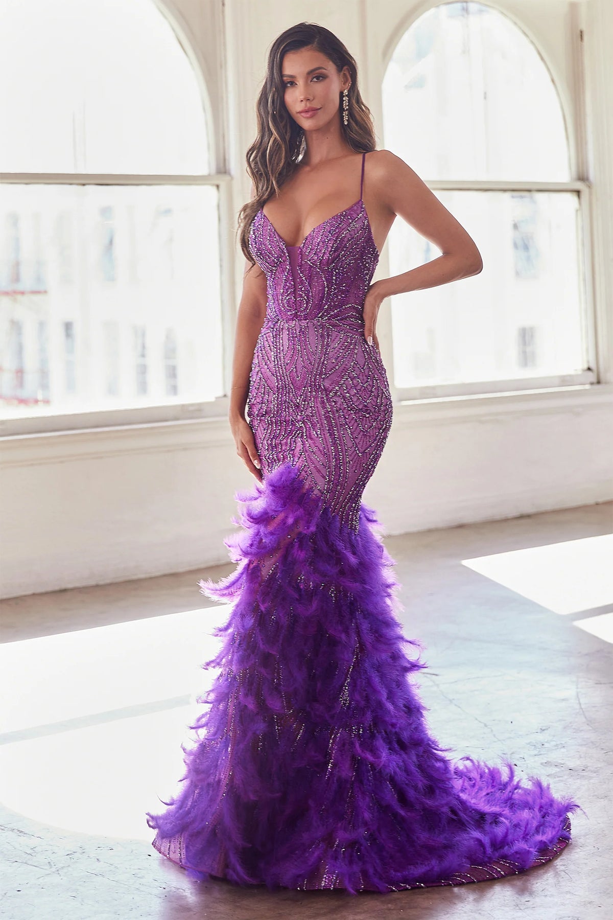 LaDivine CC2308 Enchanting Mermaid Prom Dress - A captivating mermaid silhouette dress with thin straps, v-neckline, glitter and bead embellishments on the sheer boned bodice, a tiered feathered skirt, and an open lace-up corset back.  The model is wearing the dress in Nova Purple.