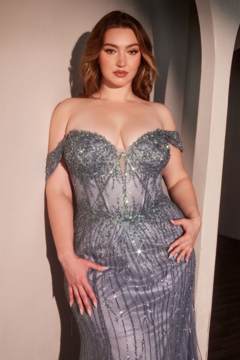 Woman wearing a sparkling off-shoulder gown against a neutral background