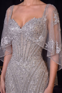 Ladivine CD637 embellished corset gown with sweetheart neckline, intricate crystal beadwork, floral detailing and flowing cape-style sleeves.