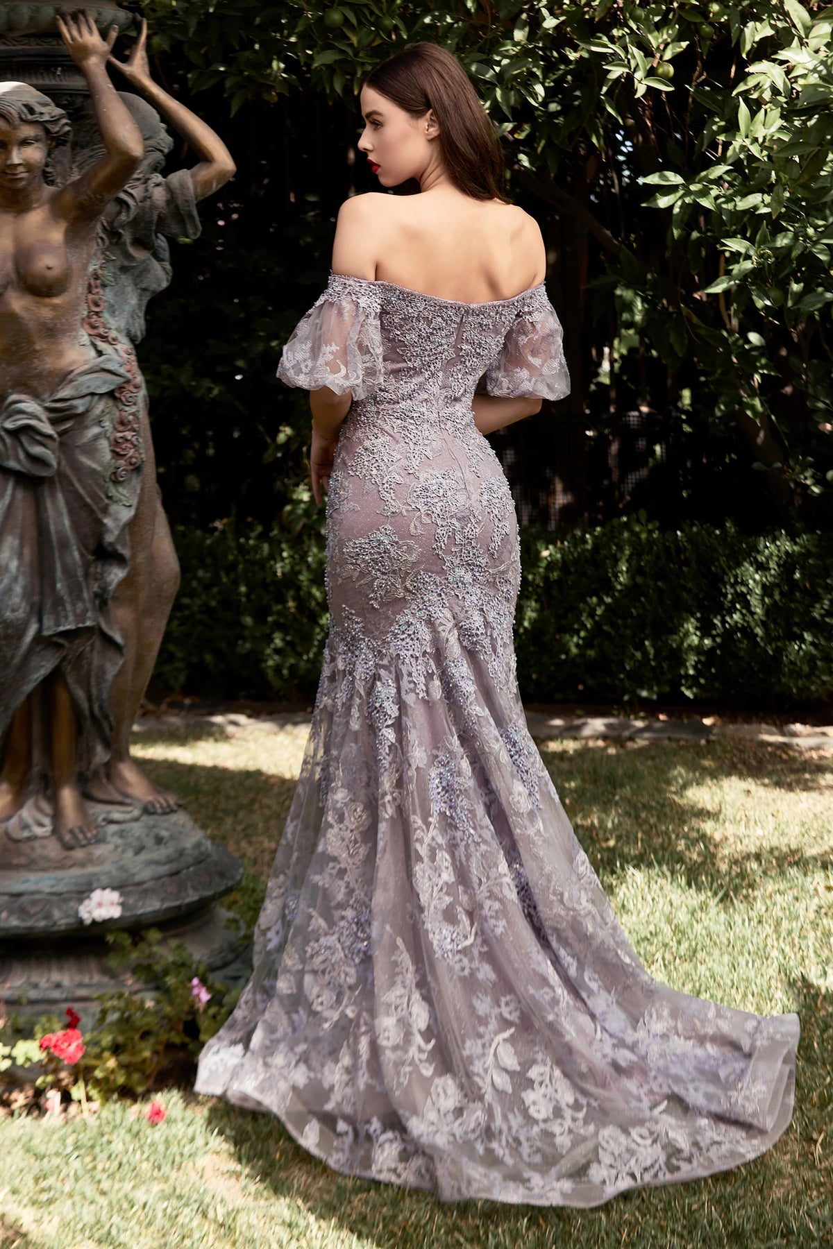 LaDivine CD959 Enchanting Lace Off-the-Shoulder Mermaid Gown, featuring a fitted silhouette, off-the-shoulder neckline, puff sleeves, and intricate lace detailing from head to toe. Perfect for elegant evening occasions.  This is a back view of the dress in color Violet.