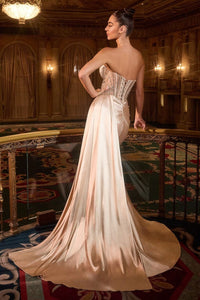 Model wearing Ladivine KV1131 strapless sweetheart gown with embellished bodice, leg slit, and flowing satin sash.
