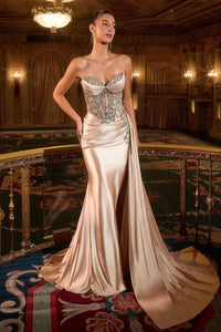 Model wearing Ladivine KV1131 strapless sweetheart gown with embellished bodice, leg slit, and flowing satin sash.