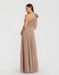 Model wearing the Mac Duggal 11879 one-shoulder gown with a 3D ruffled shoulder detail, pleated waistband, and flowing A-line skirt.
