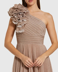 Model wearing the Mac Duggal 11879 one-shoulder gown with a 3D ruffled shoulder detail, pleated waistband, and flowing A-line skirt.