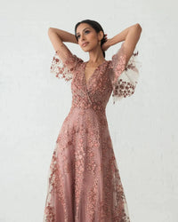 Model wearing Mac Duggal 20486 gown with faux wrap v-neckline, flutter sleeves, and rhinestone floral embellishments.