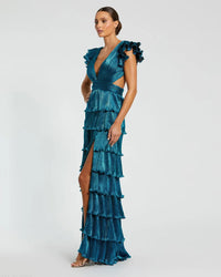 Model wearing Mac Duggal 26740 gown with deep V-neckline, ruffled sleeves, tiered pleated skirt, lace-up back, and thigh-high slit.  Model is wearing the color blue.  Side 3/4 front view of the dress.