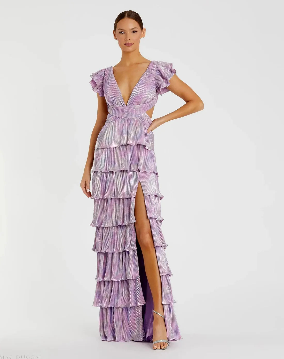 Model wearing Mac Duggal 26740 gown with deep V-neckline, ruffled sleeves, tiered pleated skirt, lace-up back, and thigh-high slit.  Model is wearing the color purple multi.  Front view.
