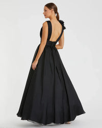 Model wearing Mac Duggal 48856 chiffon gown with V-neckline, ruffle shoulder detail, and flowing skirt.  Model wearing the color black.  Back view.