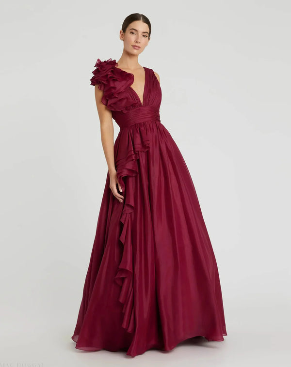 Model wearing Mac Duggal 48856 chiffon gown with V-neckline, ruffle shoulder detail, and flowing skirt.  Model wearing the color wine.  Front view.