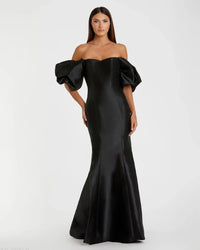 Model wearing Mac Duggal 50677 off-the-shoulder satin gown with puff sleeves, mermaid silhouette, and sweeping train.  Model is wearing the color black. Front view.