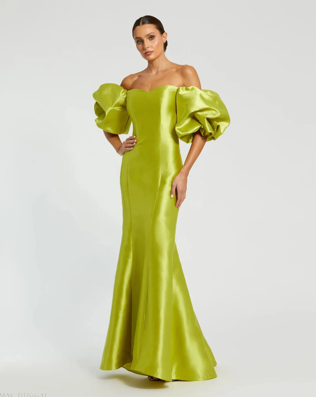 Model wearing Mac Duggal 50677 off-the-shoulder satin gown with puff sleeves, mermaid silhouette, and sweeping train.  Model is wearing the color chartreuse. Front view.