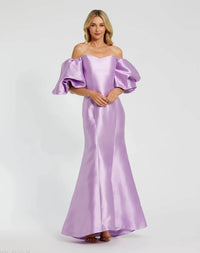Model wearing Mac Duggal 50677 off-the-shoulder satin gown with puff sleeves, mermaid silhouette, and sweeping train.  Model is wearing the color lilac. Front view.