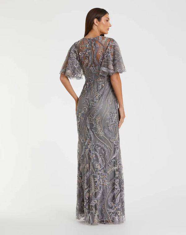 Model wearing the Mac Duggal 68918 gown with a high round neckline, flutter sleeves, allover sequin and beaded detailing, and a trumpet silhouette.