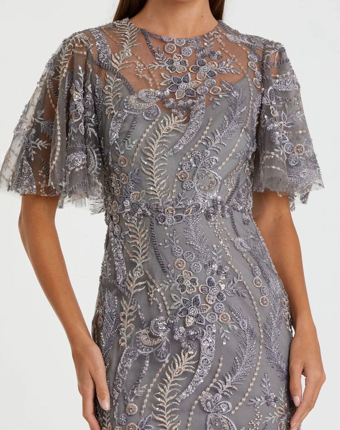 Model wearing the Mac Duggal 68918 gown with a high round neckline, flutter sleeves, allover sequin and beaded detailing, and a trumpet silhouette.  Close up.