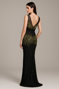 Model wearing the Mandalay C802112DEBL gown featuring an illusion neckline, intricate embellishments, and a fitted evening silhouette.