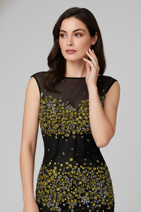 Model wearing the Mandalay C802112DEBL gown featuring an illusion neckline, intricate embellishments, and a fitted evening silhouette.