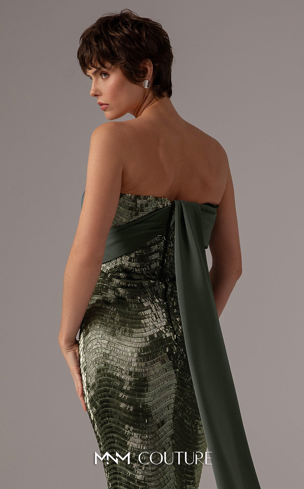 Model wearing the MNM Couture E0087 one-shoulder fitted evening gown with draped bodice and sequin detailing, shown in front and back views.