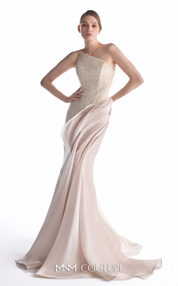 A model wearing a one-shoulder evening gown with a textured champagne-beige bodice and a flowing blush pink skirt, shown against a plain white studio background. The brand name 'MM COUTURE' is visible at the bottom.