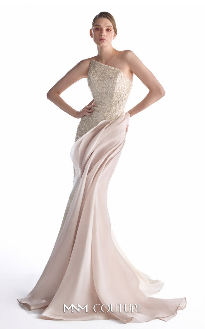 A model wearing a one-shoulder evening gown with a textured champagne-beige bodice and a flowing blush pink skirt, shown against a plain white studio background. The brand name 'MM COUTURE' is visible at the bottom.