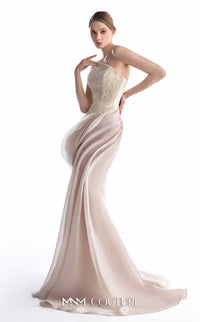 A woman modeling a floor-length evening gown with a fitted, embellished nude-beige bodice and a flowing pale blush skirt, photographed against a plain white studio background.
