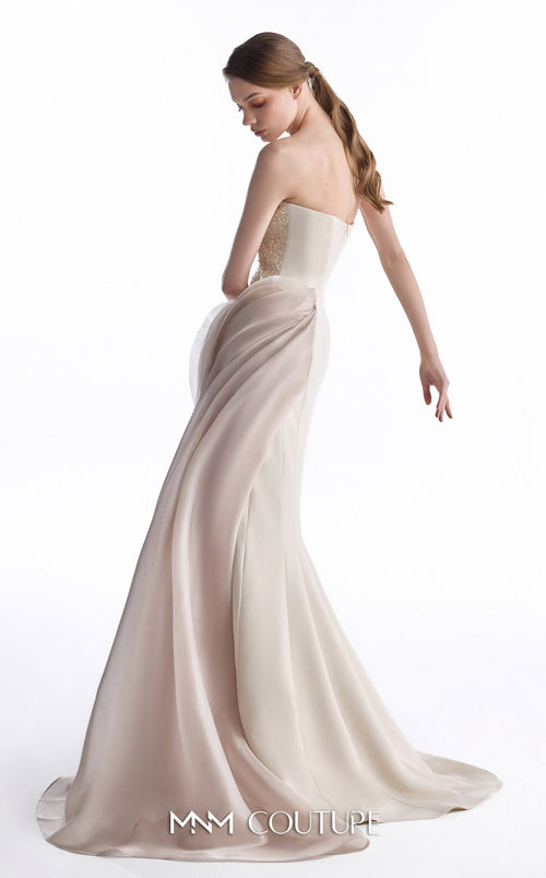A woman modeling a strapless ivory wedding gown with a fitted bodice and a flowing satin skirt, photographed against a clean white studio background.