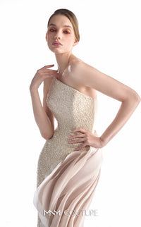 A model wearing a strapless champagne-colored evening gown with a heavily beaded textured bodice and a flowing satin skirt, posed against a solid white background. The brand name 'MM COUTURE' is visible at the bottom.
