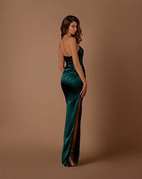 Model wearing Nicoletta NBM1028 one-shoulder satin gown in bottle green with side slit.