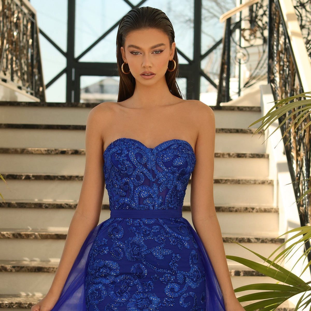 Nicoletta NC1003 Elegant Strapless Evening Dress - A captivating full-length gown with a sweetheart neckline, featuring a removable tulle skirt overlay adorned with Lace Applique for a touch of glamour. This is a picture of the front of the dress in the color royal close up.