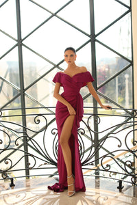 Nicoletta off-the-shoulder dress style NC1040 - Ruched bodice, sweetheart neckline, thigh-high slit, and side ruffle. Perfect for formal evening events and special occasions.