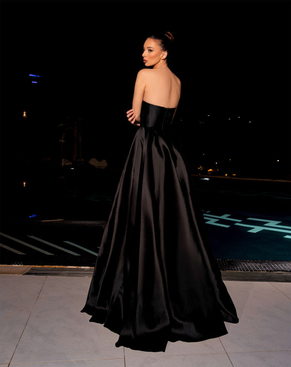 Model wearing the Nicoletta NC2030 strapless satin gown with a draped bodice and high slit, available in powder blue and black.