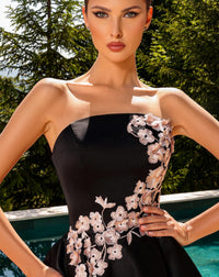 Model wearing Nicoletta NC2079 strapless navy and black A-line dress with floral appliqué and full midi skirt.