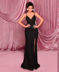 Model wearing Nicoletta NC3008 gown in lemon with lace-up corset back, floral embellishments, and front slit.