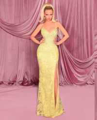 Model wearing Nicoletta NC3008 gown in lemon with lace-up corset back, floral embellishments, and front slit.