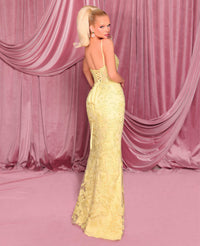 Model wearing Nicoletta NC3008 gown in lemon with lace-up corset back, floral embellishments, and front slit.