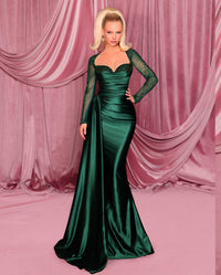 Model wearing Nicoletta NC3078 long sleeve embellished evening gown with sweetheart bodice, draped waist, and fit & flare silhouette.  Model is wearing the color deep emerald.  Front View.