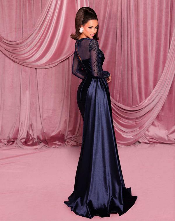 Model wearing Nicoletta NC3078 long sleeve embellished evening gown with sweetheart bodice, draped waist, and fit & flare silhouette.  Model is wearing the color mid-night.  Rear View.