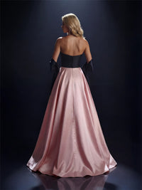 Model wearing Nicoletta NC4042 strapless ball gown with full overskirt and front slit.
