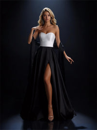 Model wearing Nicoletta NC4042 strapless ball gown with full overskirt and front slit.