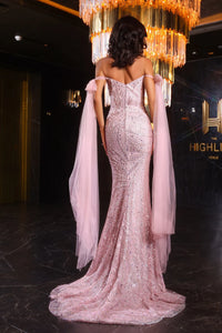 Model wearing Portia & Scarlett PS25698E off-shoulder mermaid gown with sparkle embellishments and draped sleeves.