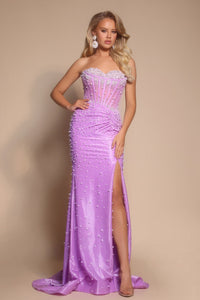 Woman wearing a strapless, beaded purple evening gown with a high slit on a beige background