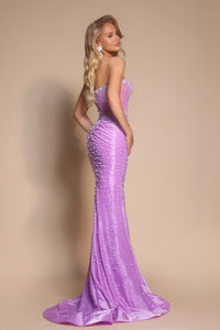Woman wearing a lilac beaded evening gown against a beige background
